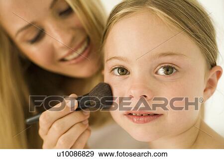 Stock Photo - Mother and daughter with makeup. Fotosearch