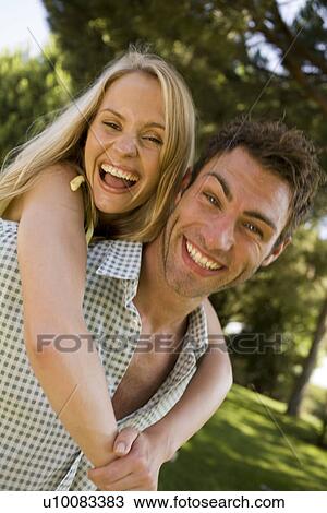 Stock Image - Young couple in park. Fotosearch