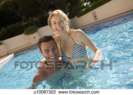 Young couple in pool View Large Photo Image Stock Image - Young couple in pool. Fotosearch