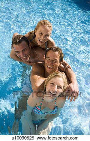Stock Photography - Young couples in pool. Fotosearch