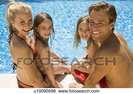 Stock Photograph - Family by pool. Fotosearch