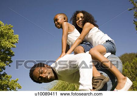 Stock Image - Family in park. Fotosearch