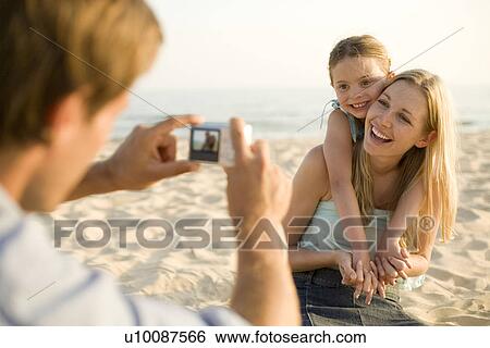 Family on beach with camera View Large Photo Image Stock Photograph - Family on beach with camera. Fotosearch