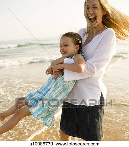 Family playing on beach View Large Photo Image Stock Photo - Family playing on beach. Fotosearch