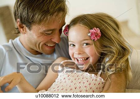 Stock Image - Father and daughter at home. Fotosearch