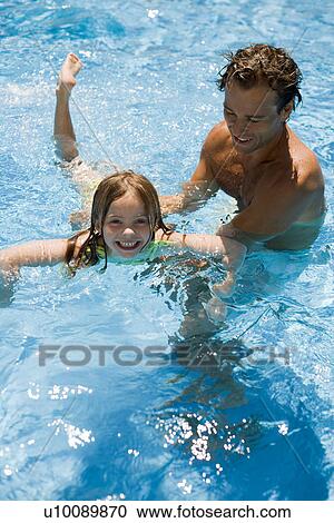 Father and daughter playing in pool View Large Photo Image Stock Image - Father and daughter playing in pool. Fotosearch