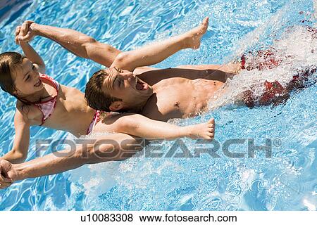 Father and daughter playing in pool View Large Photo Image Stock Photo - Father and daughter playing in pool. Fotosearch
