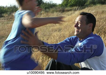 Father and son playing in park View Large Photo Image Stock Photography - Father and son playing in park. Fotosearch