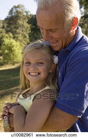 Grandfather and granddaughter in park View Large Photo Image Stock Image - Grandfather and granddaughter in park. Fotosearch