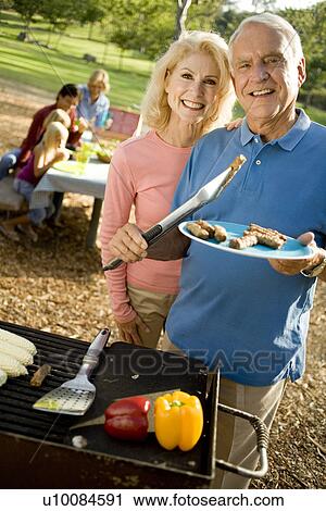 Grandparents and family in park with barbeque View Large Photo Image Stock Image - Grandparents and family in park with barbeque. Fotosearch