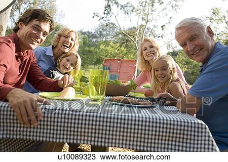 Grandparents and family in park with picnic View Large Photo Image Stock Image - Grandparents and family in park with picnic. Fotosearch