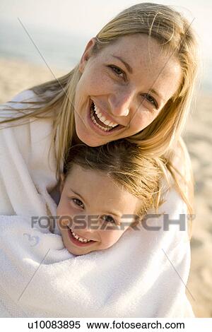 Stock Photography - Mother and daughter on beach. Fotosearch