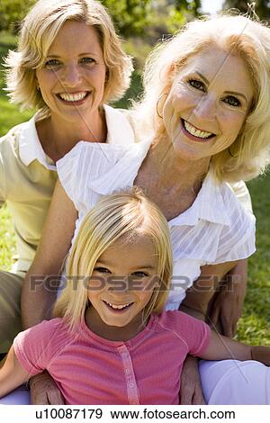 Stock Photo - Mother daughter and granddaughter in park. Fotosearch