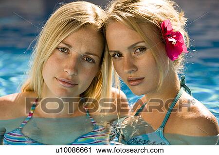Stock Image - Two women in pool. Fotosearch
