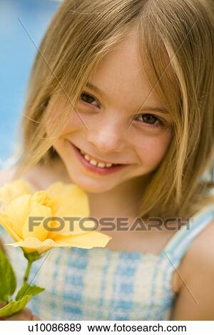 Young girl with flower View Large Photo Image Stock Photo - Young girl with flower. Fotosearch