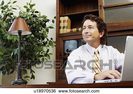 Stock Photograph - Businessman using a laptop. Fotosearch