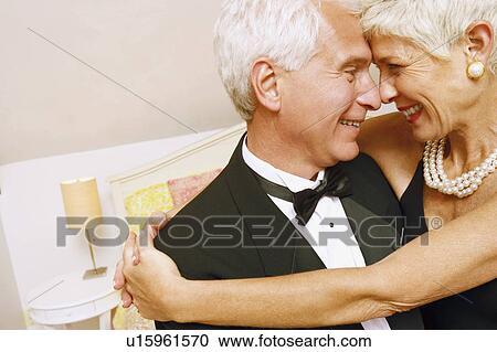 Close-up of a senior woman embracing a mature man and smiling View Large Photo Image Stock Image - Close-up of a senior woman embracing a mature man and smiling. Fotosearch