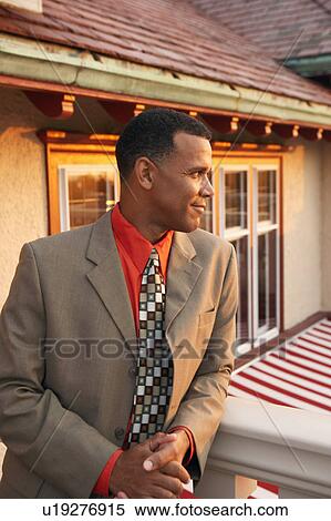 Mature man leaning against a balustrade View Large Photo Image Stock Photography - Mature man leaning against a balustrade. Fotosearch