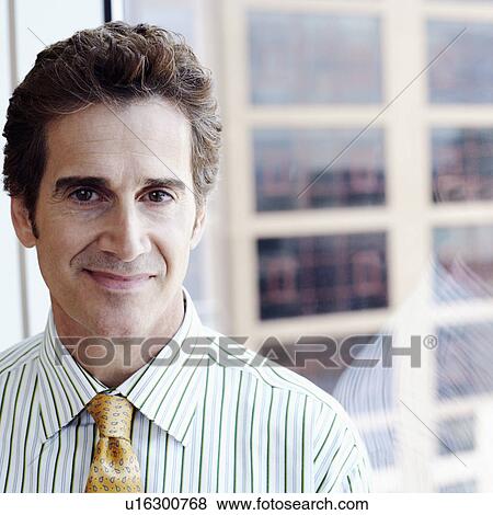 Portrait of a businessman smirking View Large Photo Image Stock Photo - Portrait of a businessman smirking. Fotosearch