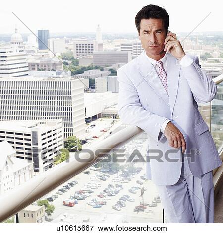 Portrait of a businessman talking on a mobile phone View Large Photo Image Stock Photo - Portrait of a businessman talking on a mobile phone. Fotosearch