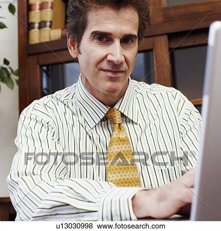 Portrait of a businessman using a laptop View Large Photo Image Stock Photo - Portrait of a businessman using a laptop. Fotosearch