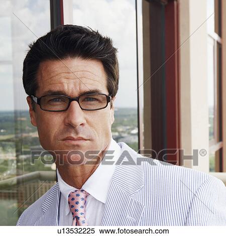Portrait of a businessman wearing eyeglasses View Large Photo Image Stock Photography - Portrait of a businessman wearing eyeglasses. Fotosearch