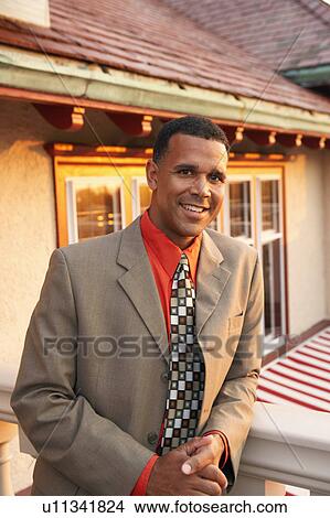 Picture - Portrait of a mature man leaning against a balustrade. Fotosearch