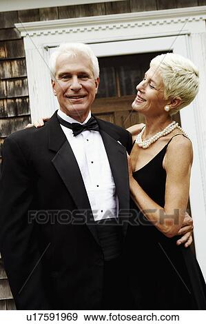Portrait of a mature man standing with his arm around a senior woman View Large Photo Image Stock Photo - Portrait of a mature man standing with his arm around a senior woman. Fotosearch