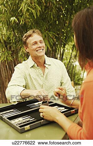 Close-up of a mature man and a mature woman playing backgammon View Large Photo Image Stock Image - Close-up of a mature man and a mature woman playing backgammon. Fotosearch