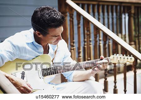 Stock Photo - Mature man playing the guitar. Fotosearch