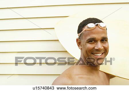 Portrait of a mature man carrying a surfboard and smiling View Large Photo Image Stock Image - Portrait of a mature man carrying a surfboard and smiling. Fotosearch