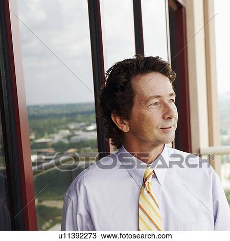 Close-up of a businessman standing with his hands in his pockets View Large Photo Image Stock Image - Close-up of a businessman standing with his hands in his pockets. Fotosearch