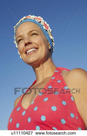 Low angle view of a mature woman smiling View Large Photo Image Stock Photo - Low angle view of a mature woman smiling. Fotosearch