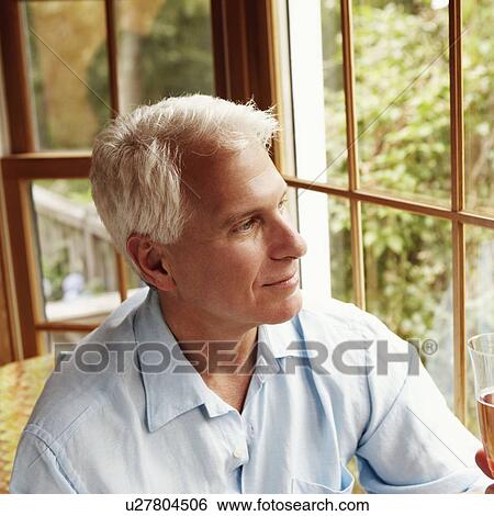 Mature man holding a champagne flute View Large Photo Image Stock Photograph - Mature man holding a champagne flute. Fotosearch