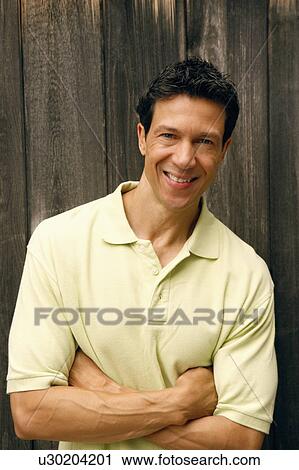 Portrait of a mature man with his arms crossed smiling View Large Photo Image Stock Image - Portrait of a mature man with his arms crossed smiling. Fotosearch