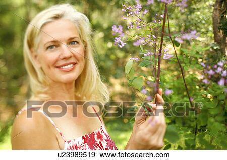 Portrait of a mature woman smiling View Large Photo Image Stock Photo - Portrait of a mature woman smiling. Fotosearch