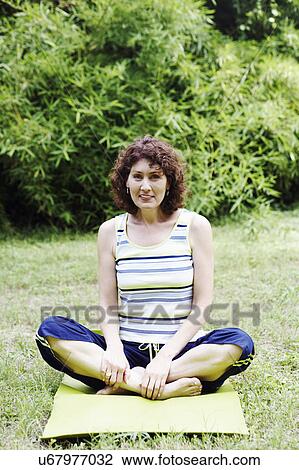 Mature woman exercising on the lawn View Large Photo Image Stock Image - Mature woman exercising on the lawn. Fotosearch