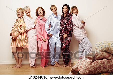 Stock Photograph - Portrait of a group of people standing together and smiling. Fotosearch