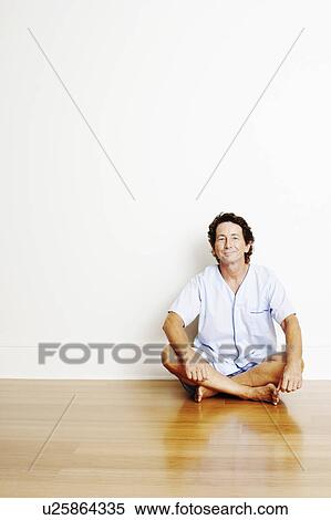 Portrait of a mature man sitting cross-legged on the floor and smiling View Large Photo Image Stock Photography - Portrait of a mature man sitting cross-legged on the floor and smiling. Fotosearch