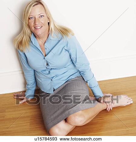 Portrait of a mature woman kneeling on the floor and smiling View Large Photo Image Stock Image - Portrait of a mature woman kneeling on the floor and smiling. Fotosearch