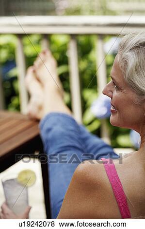 Stock Photo - Rear view of a mature woman smiling. Fotosearch