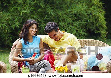 Mature man holding a glass of lemonade with a mature woman holding a slice of water melon beside him View Large Photo Image Stock Photo - Mature man holding a glass of lemonade with a mature woman holding a slice of water melon beside him. Fotosearch