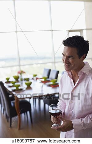 Stock Photo - Mature man holding a glass of wine. Fotosearch