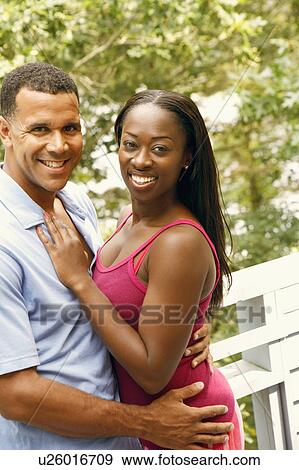 Portrait of a mature man embracing a mid adult woman and smiling View Large Photo Image Stock Photo - Portrait of a mature man embracing a mid adult woman and smiling. Fotosearch