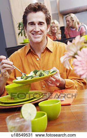 Portrait of a mature man holding a plate of salad and smiling View Large Photo Image Stock Image - Portrait of a mature man holding a plate of salad and smiling. Fotosearch
