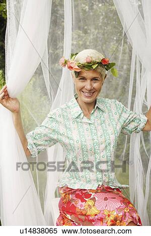 Portrait of a senior woman sitting and smiling View Large Photo Image Stock Photography - Portrait of a senior woman sitting and smiling. Fotosearch