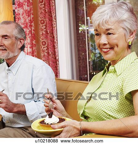Side profile of a mature woman eating a tart View Large Photo Image Stock Photo - Side profile of a mature woman eating a tart. Fotosearch