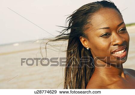 Stock Photo - Close-up of a mid adult woman smiling. Fotosearch