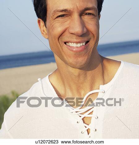 Portrait of a mature man smiling on the beach View Large Photo Image Stock Image - Portrait of a mature man smiling on the beach. Fotosearch