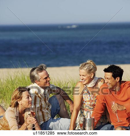 Two mature couples sitting on the beach View Large Photo Image Stock Photography - Two mature couples sitting on the beach. Fotosearch